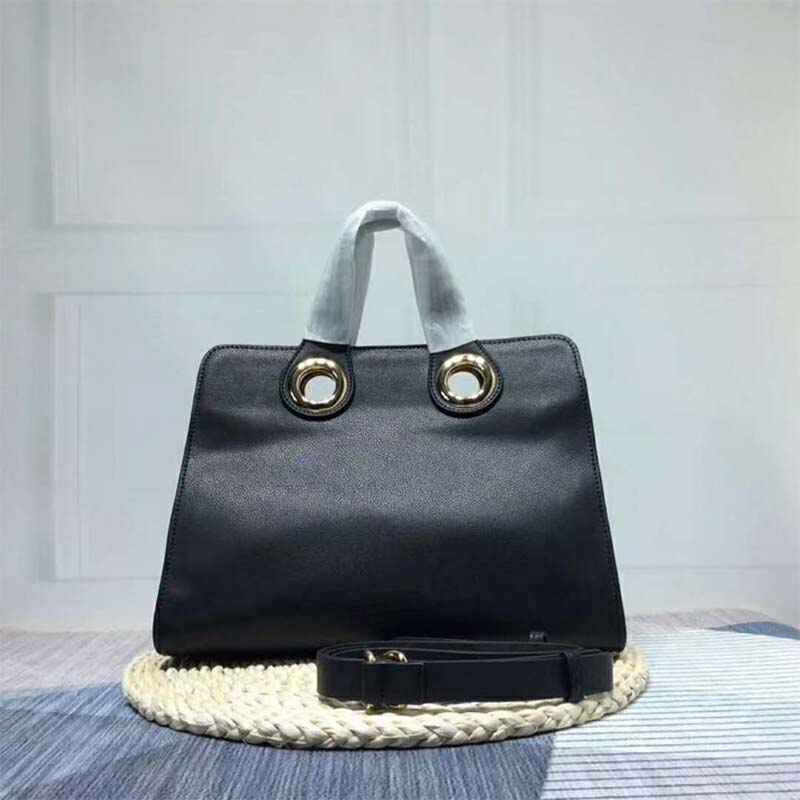 Side angle showing structured silhouette of Burberry leather crest tote