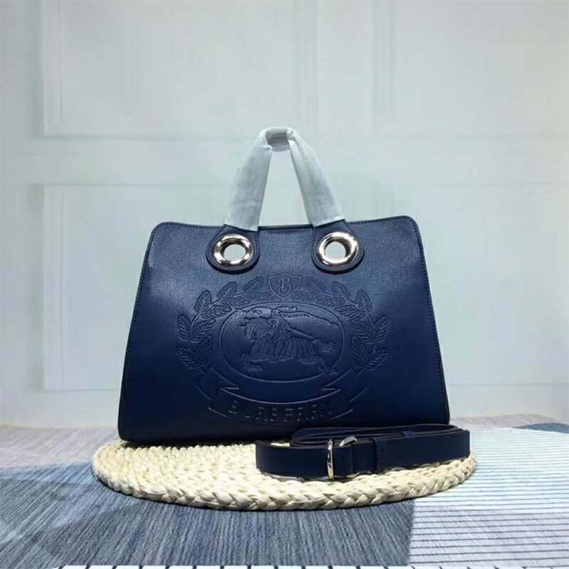 Close-up of silver grommet hardware on Burberry Women The Leather Crest Grommet Detail Tote-Blue