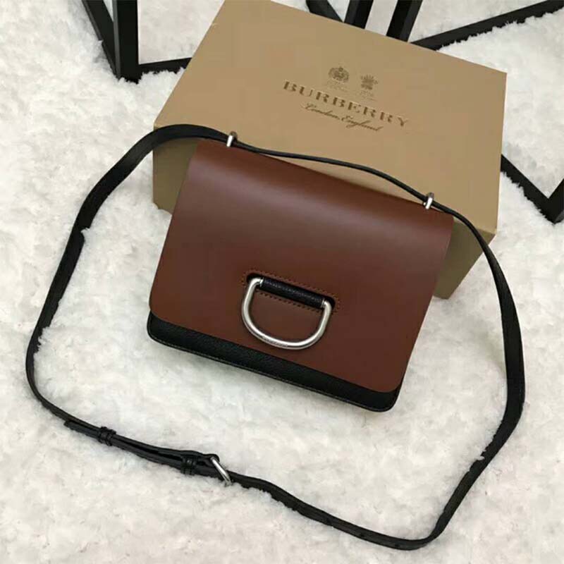Side angle showing compact silhouette of Burberry Women The Small Leather D-Ring Bag-Brown