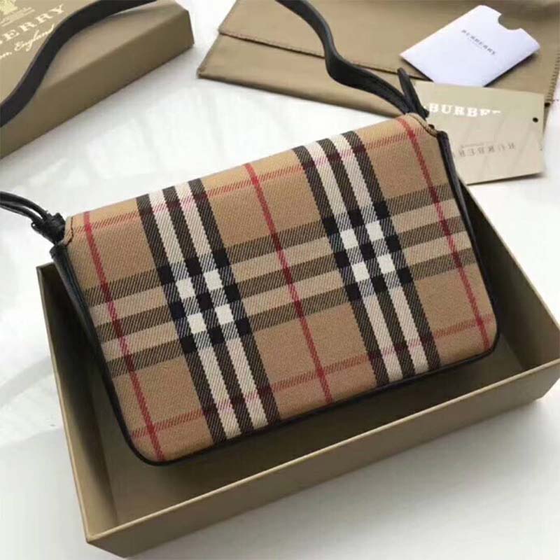 Side angle showing gold hardware and detachable strap on Burberry wallet
