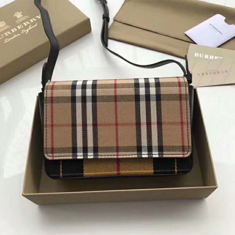 Close-up of brown leather and vintage check fabric details on wallet