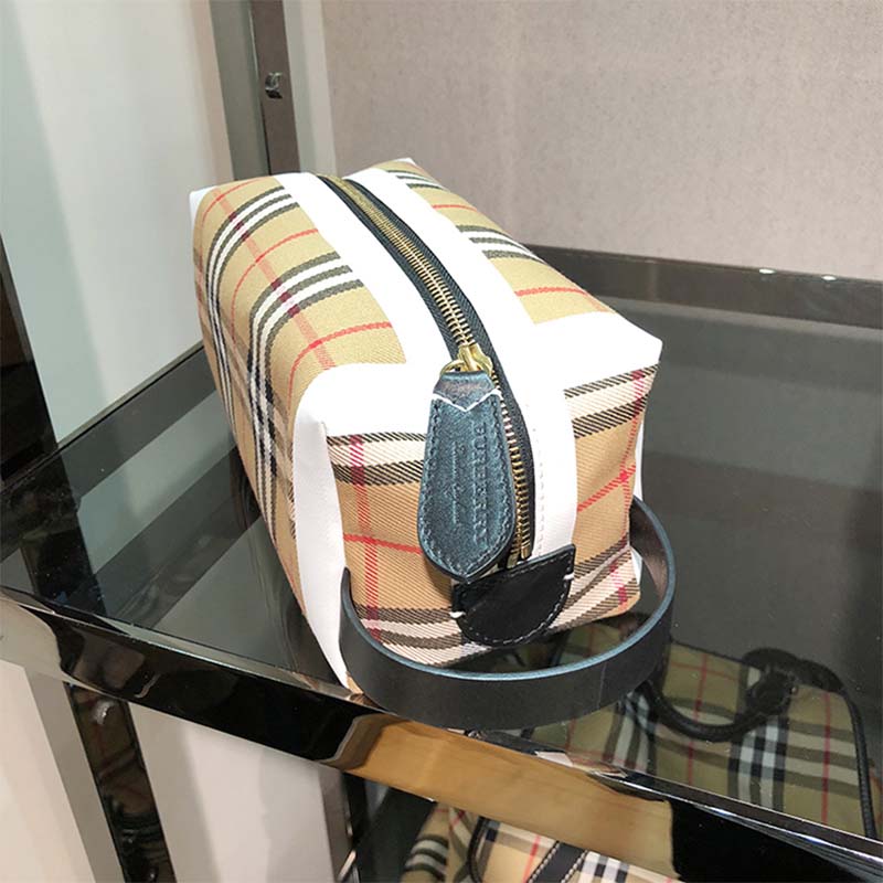 Side angle showing silver hardware on Burberry vintage check pouch