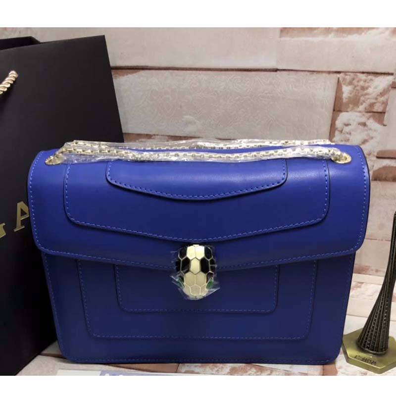 Close-up of gold snakehead clasp on Bvlgari Serpenti Forever navy bag