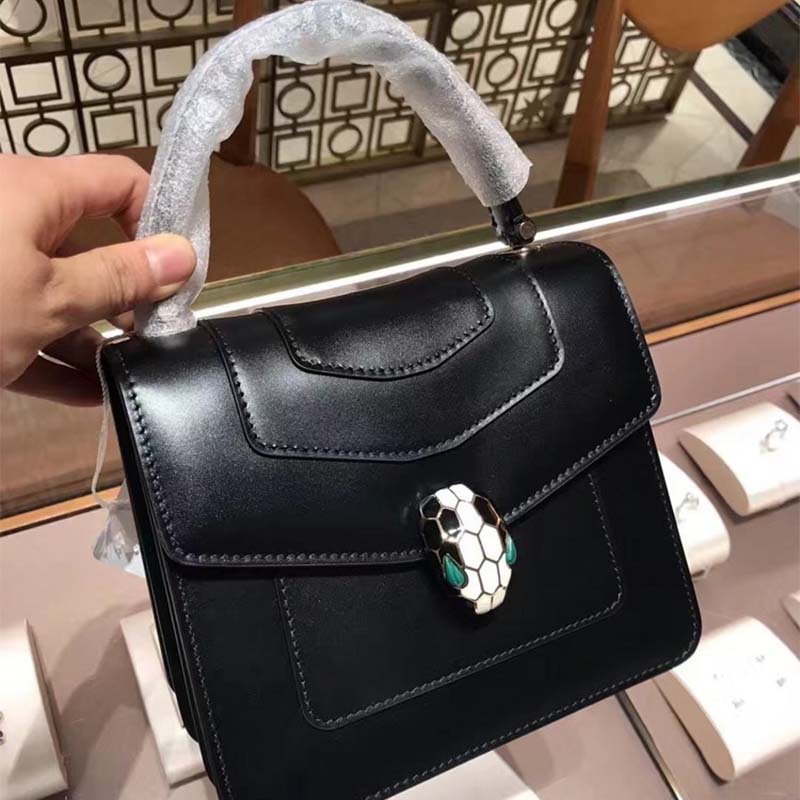 Close-up of Serpenti snakehead clasp on Bvlgari Serpenti Forever bag