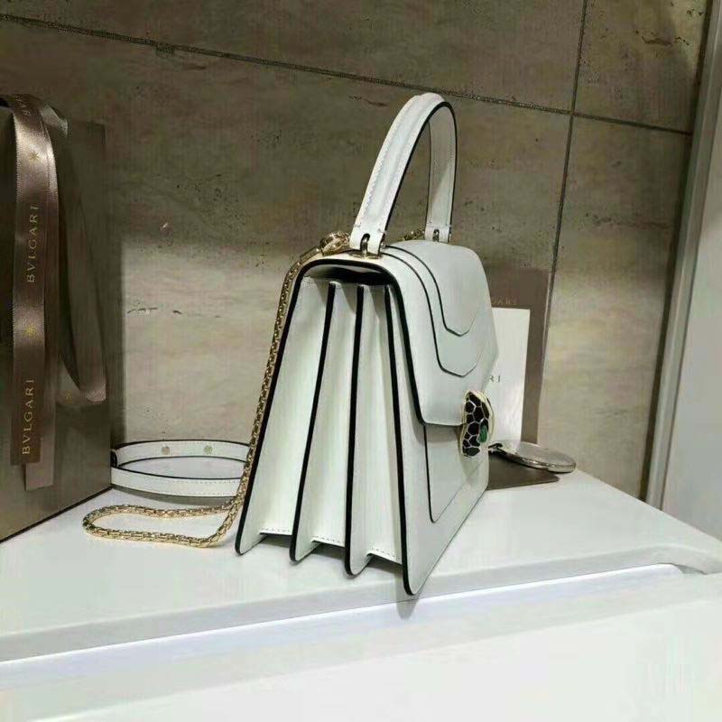 Side angle showing smooth white calfskin and structured silhouette of Bvlgari bag