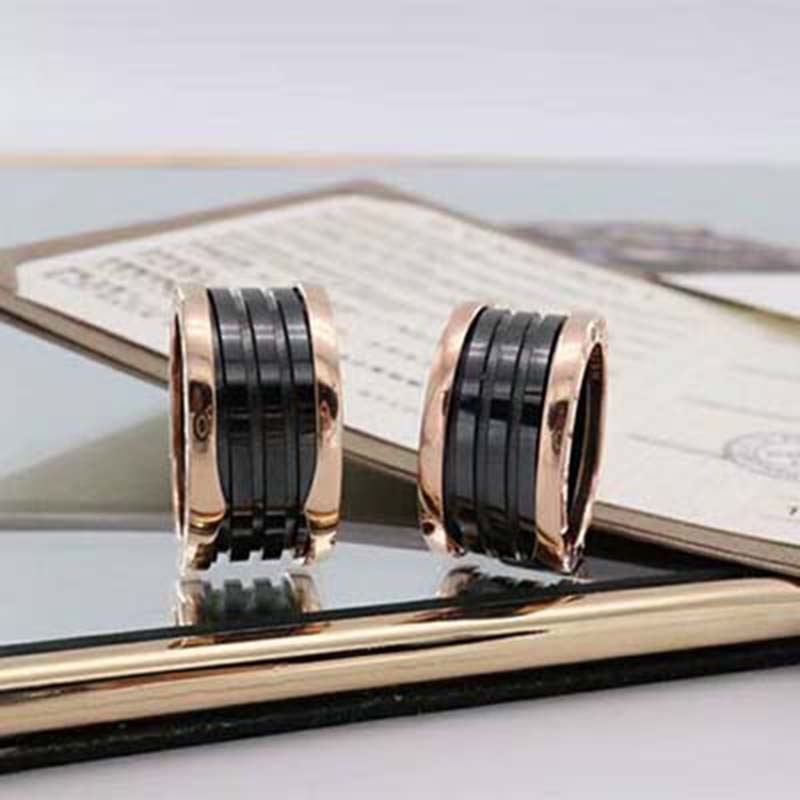 Close-up detail of engraved Bvlgari logo on Four-Band Ring in rose gold