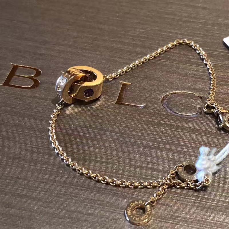 Elegant side view of Bvlgari Women Bvlgari Bvlgari 18 KT Rose Gold Bracelet Set stacked