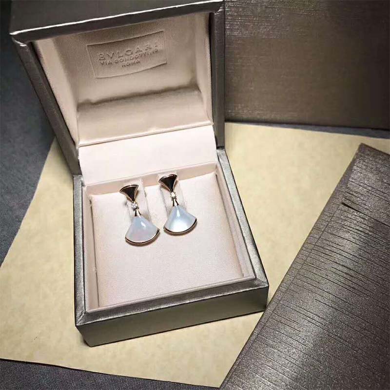Close-up on white enamel detail and rose gold finish of Bvlgari earrings