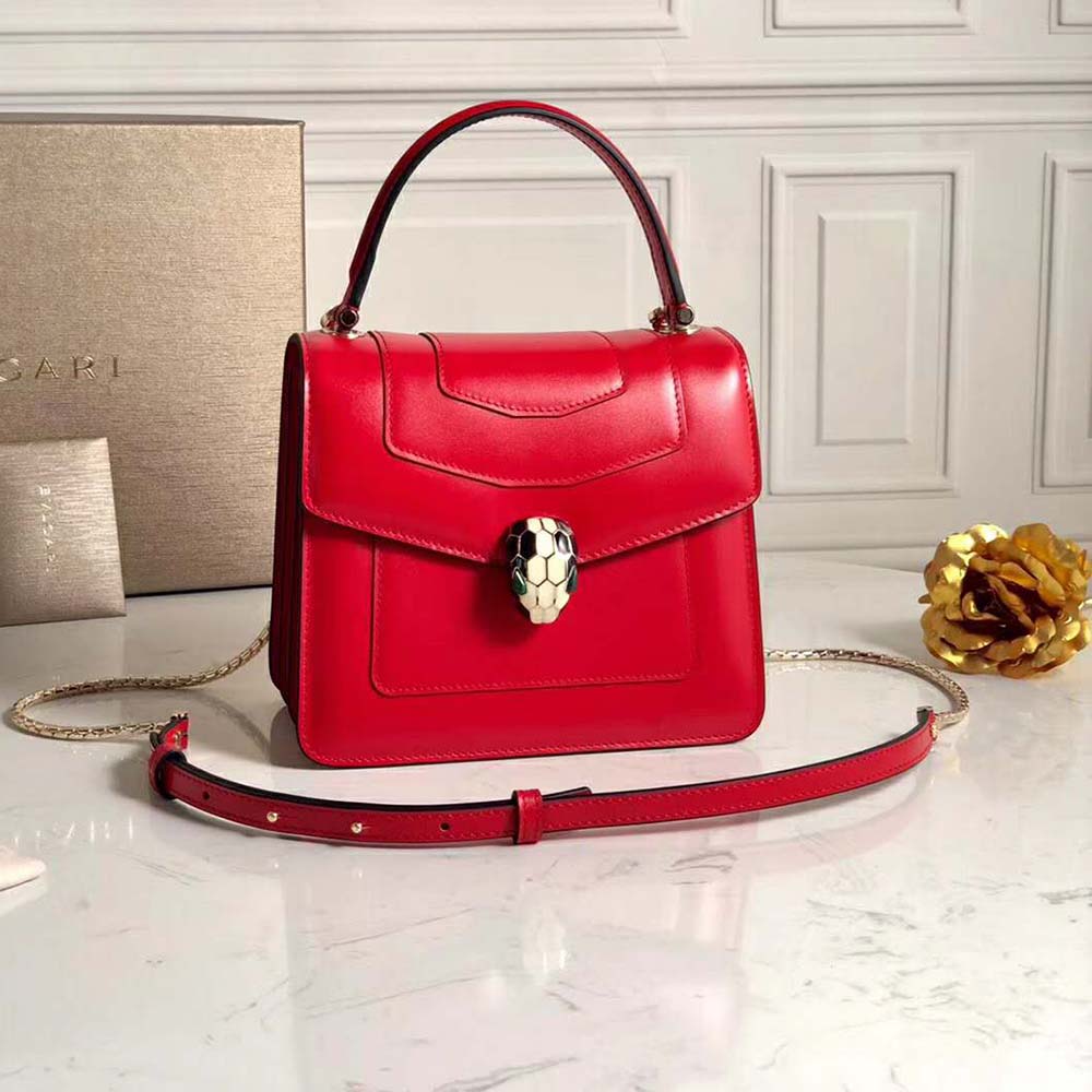 Close-up of signature snakehead clasp on Bvlgari Serpenti Forever Red bag