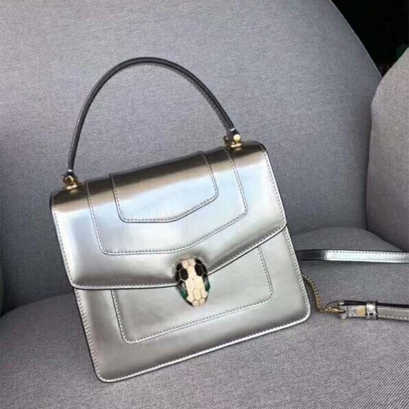 Close-up of silver serpent head clasp on Bvlgari Women Serpenti Forever bag