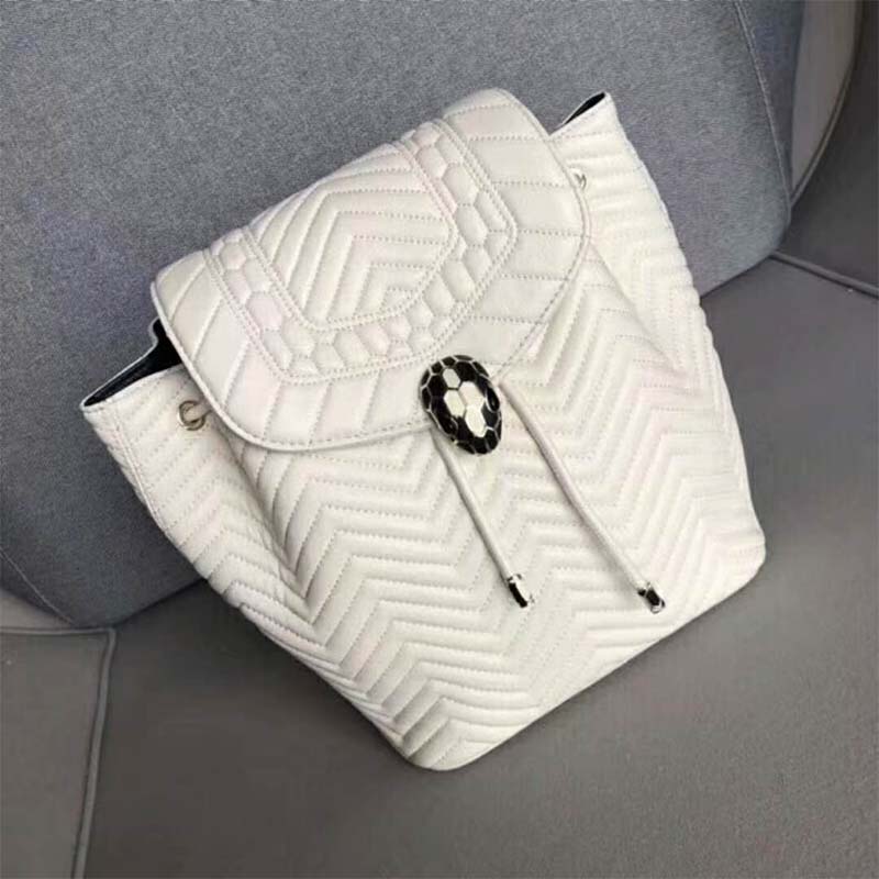 Close-up of Serpenti snake hardware on Bvlgari white leather backpack