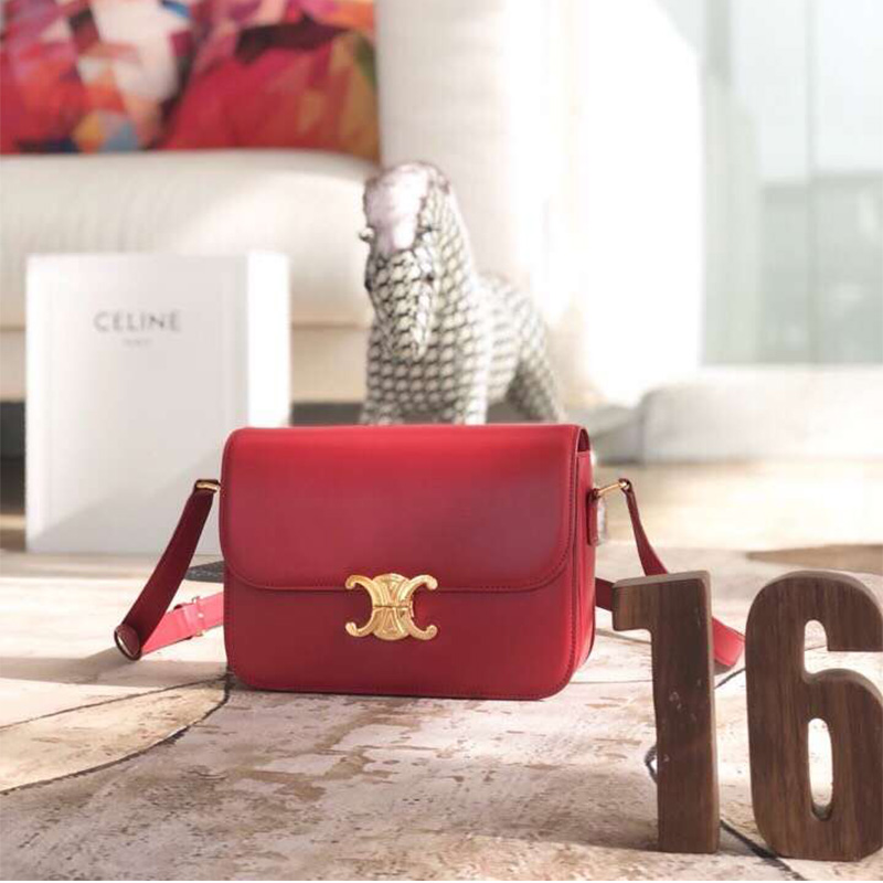 Close-up of gold Triomphe clasp on red Celine Lady Medium bag