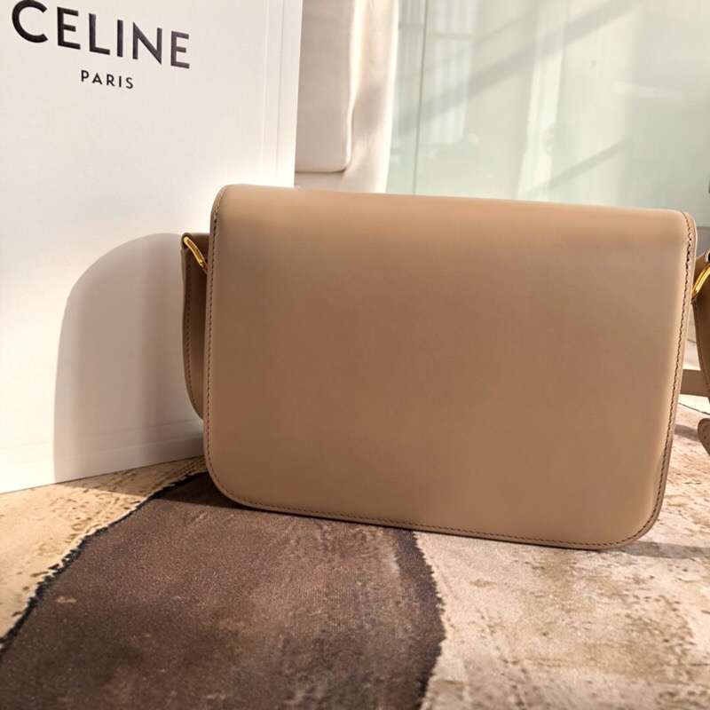 Side angle showing shoulder strap and sandy leather texture detail