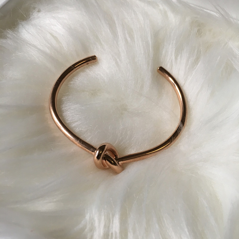 Side angle of Celine Women Knot Extra-Thin Bracelet in rhodium gold finish