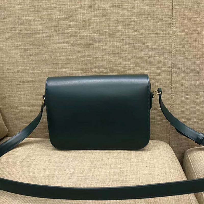 Side profile showing glossy green leather and shoulder strap
