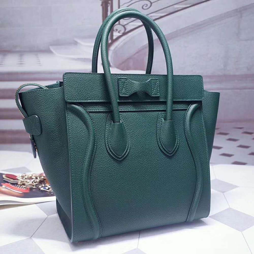 Close-up detail of gold-tone hardware on dark green Celine handbag