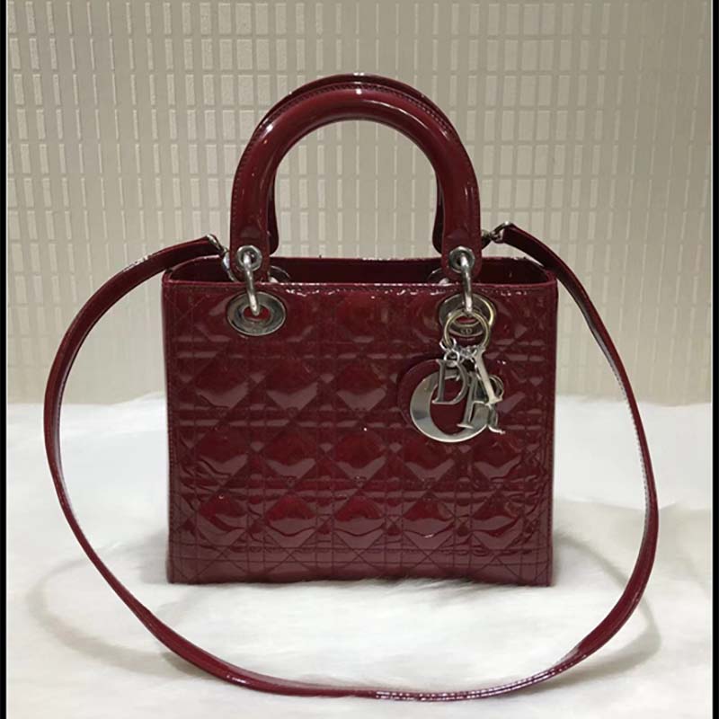 Side angle showing shoulder strap on Dior Lady Dior Bag maroon patent