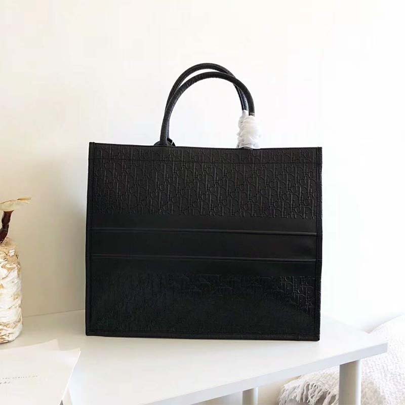 Side angle of structured silhouette on Dior Lady Dior Book Tote Bag black