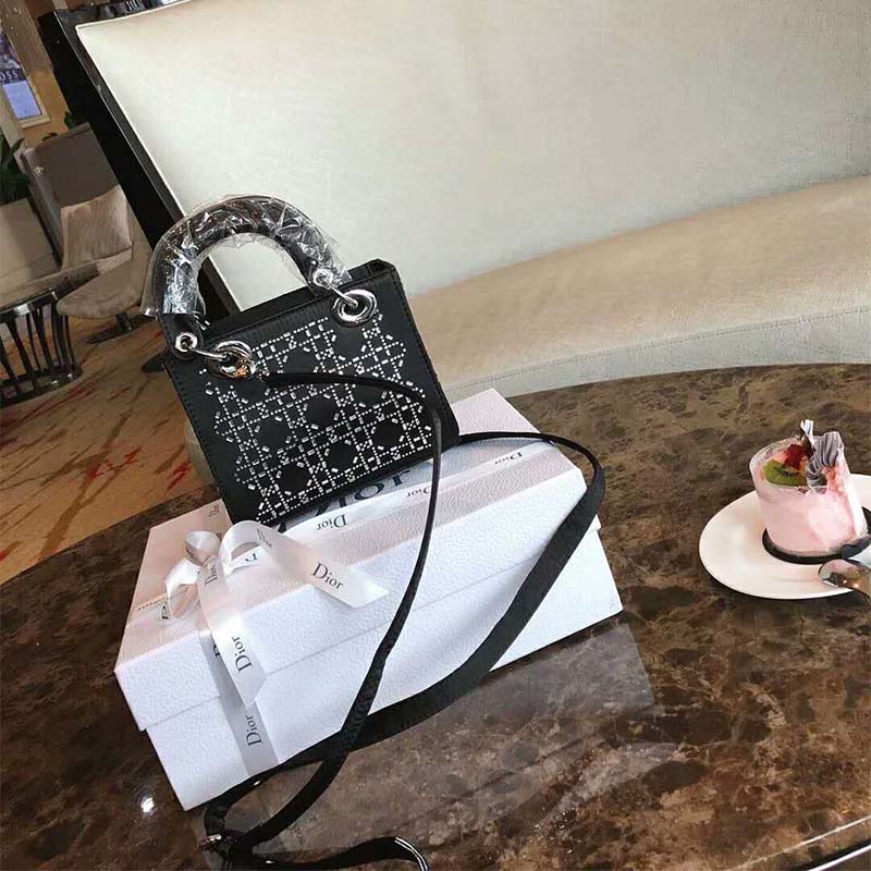 Side angle showing silver hardware on Dior Mini Lady Dior Bag in Black Satin