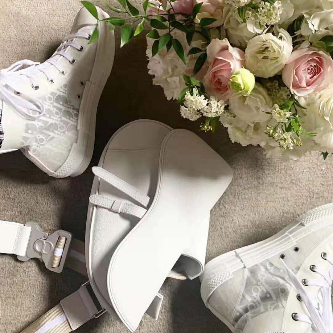 Close-up on Dior Oblique canvas and leather details in white sneaker