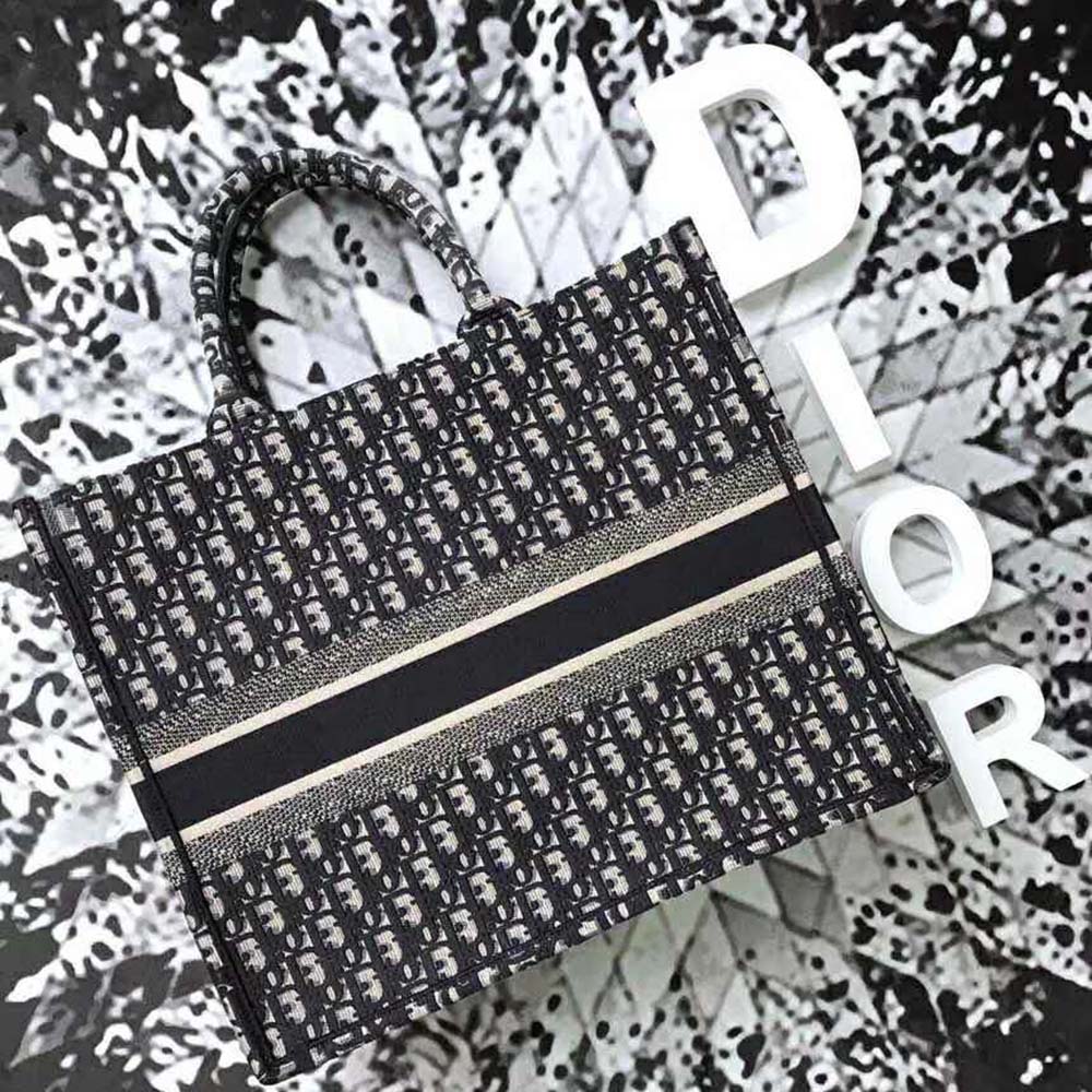 Side angle showing silver hardware and structured silhouette of Dior bag