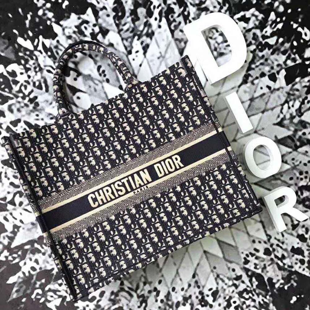 Close-up detail of silver Dior Oblique embroidery on tote canvas