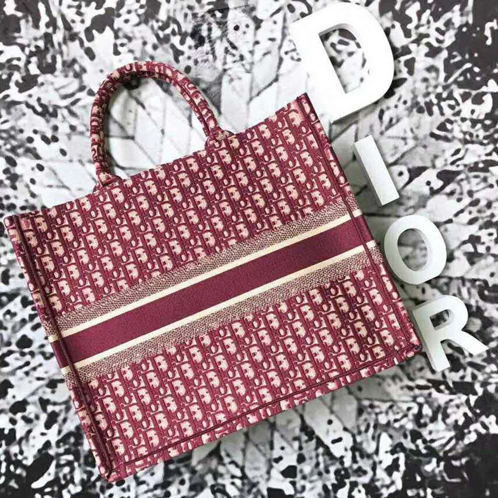 Side angle showing silver hardware and shoulder straps of Dior Women Book Tote