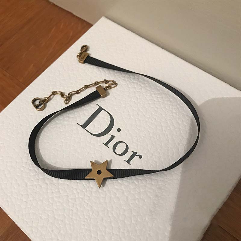 Close-up of Dior pendant charm on Women D Porte-Bonheur Choker-Black