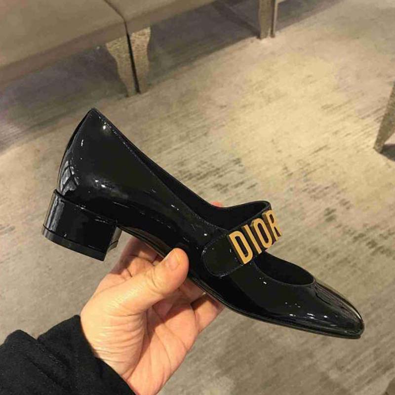 Close-up of signature silver hardware on Dior Baby-D Ballet Pump