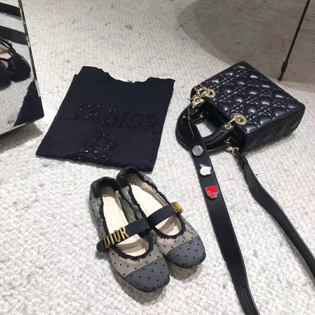 Close-up of Dior Baby-D metal buckle on Black Dotted Swiss ballet pump