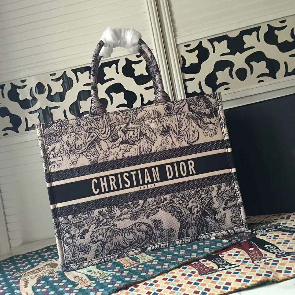 Close-up of navy Toile de Jouy canvas and silver hardware on Dior Book Tote