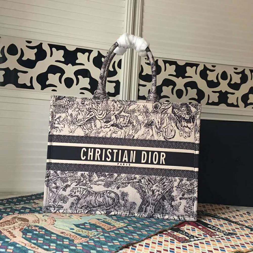 Side view of Dior Women Dior Book Tote Toile De Jouy Bag-Navy with shoulder straps