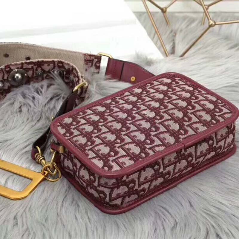 Side angle showing zipper and texture of Dior Women Diorquake Clutch