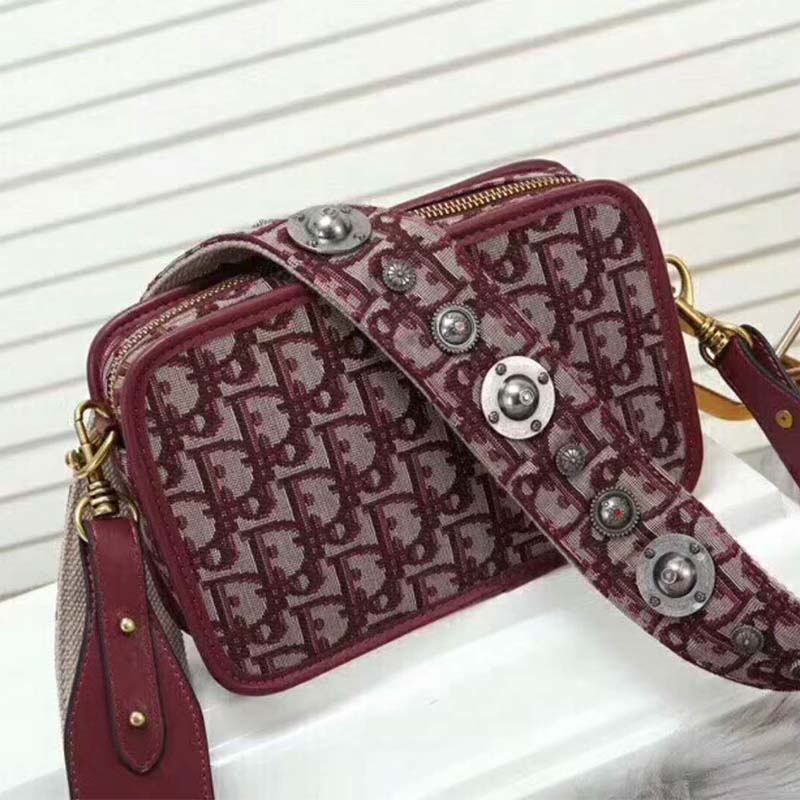 Close-up of silver Dior hardware on Diorquake Clutch in Burgundy Canvas