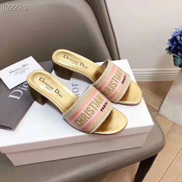 Close-up of Dior gold-tone ‘D’ hardware on embroidered mule