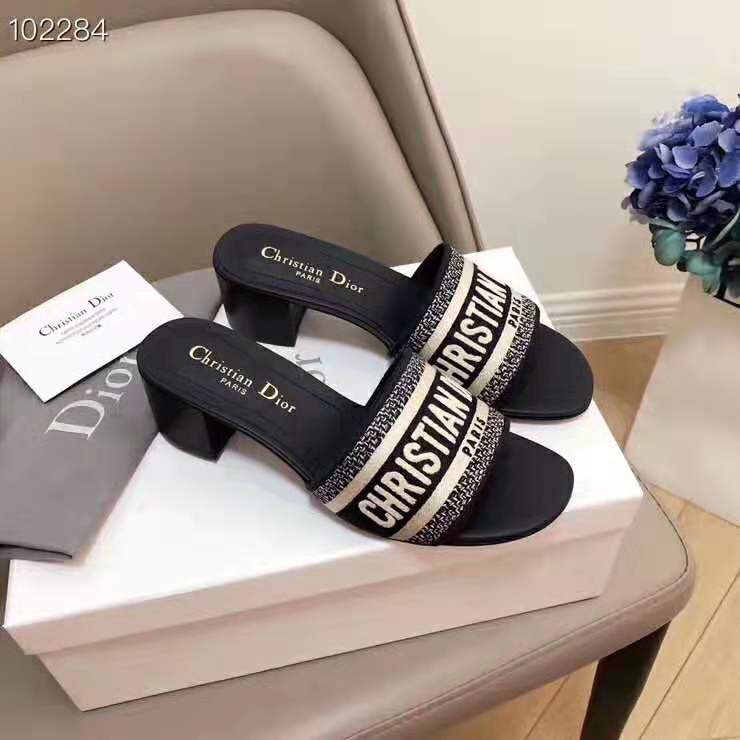 Close-up of gold-tone CD logo hardware on Dior Women Dway Mule navy shoe