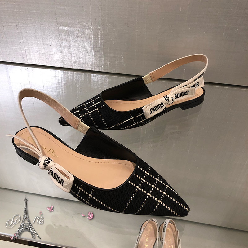 Close-up of J’Adior ribbon and gold hardware on tartan wool pump
