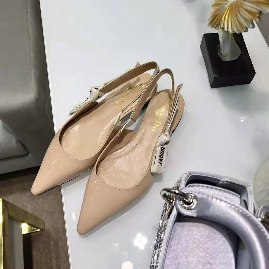 Close-up of J’adior ribbon and gold hardware on ballet pump