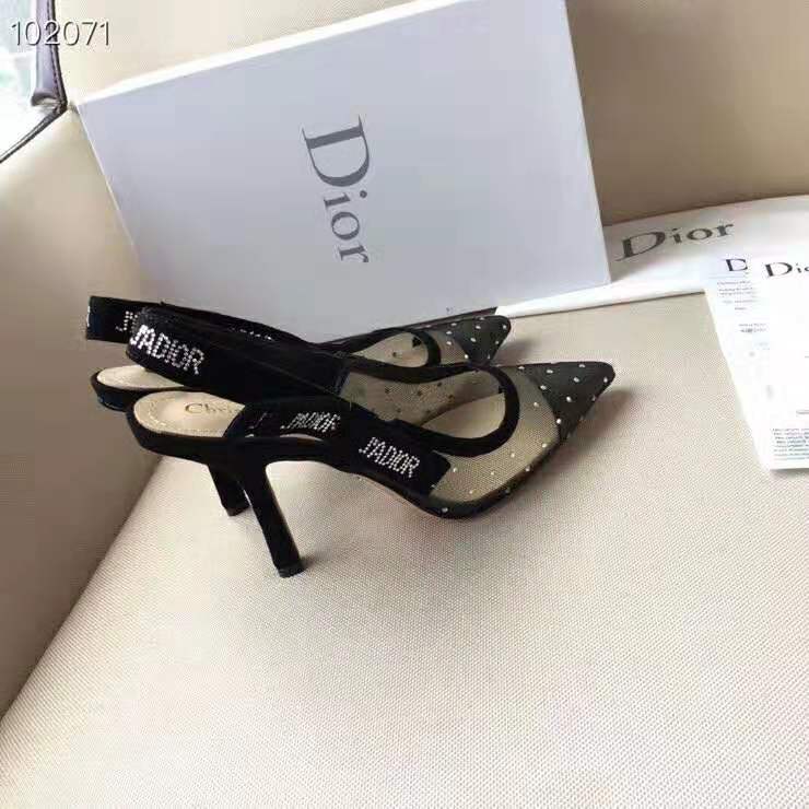 Close-up of gold-tone J’adior buckle on black slingback heel
