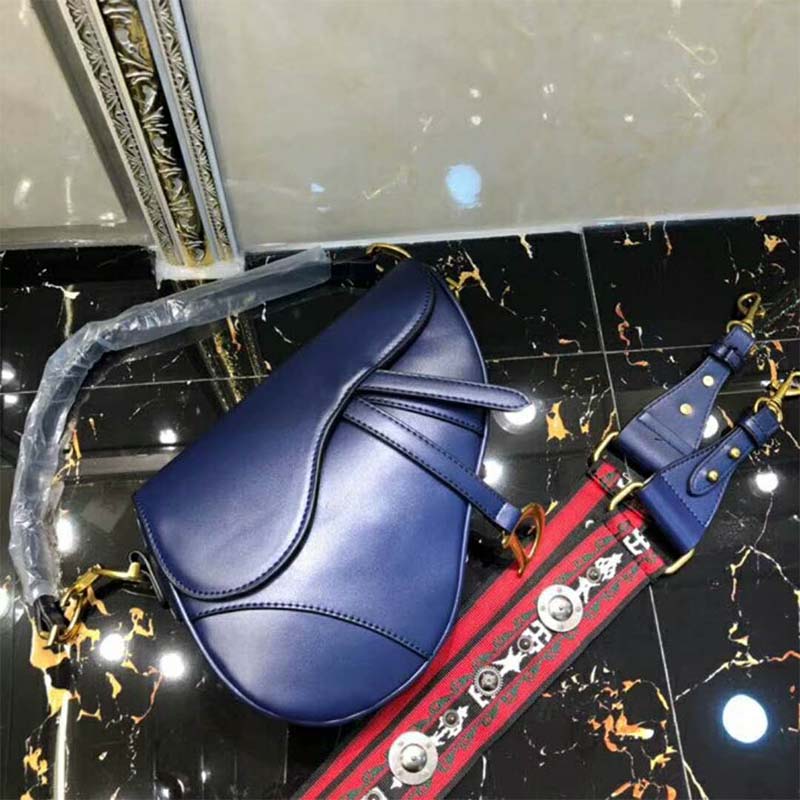 Side angle highlighting navy leather texture of Dior Women Mini Saddle Bag