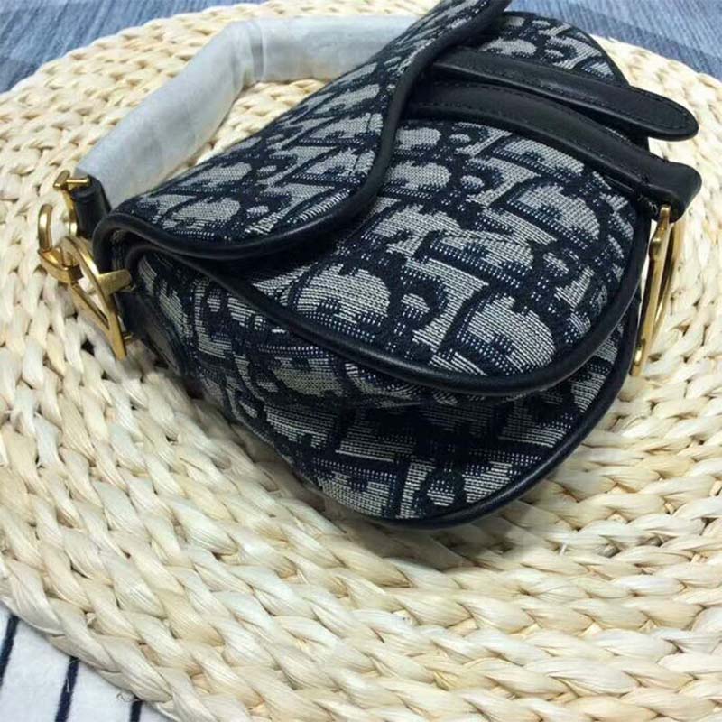 Side angle showing adjustable strap and shape of Dior Women Mini Saddle Bag