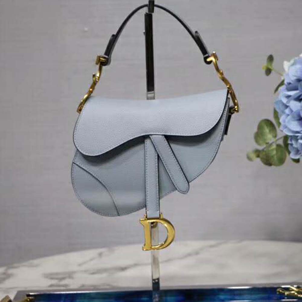 Close-up of polished silver hardware on Dior Women Mini Saddle Bag in blue leather