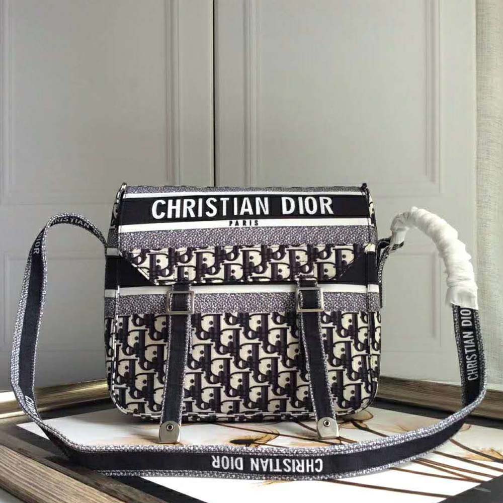 Close-up of silver-tone CD hardware on Dior Women Oblique Diorcamp Messenger Bag-Navy
