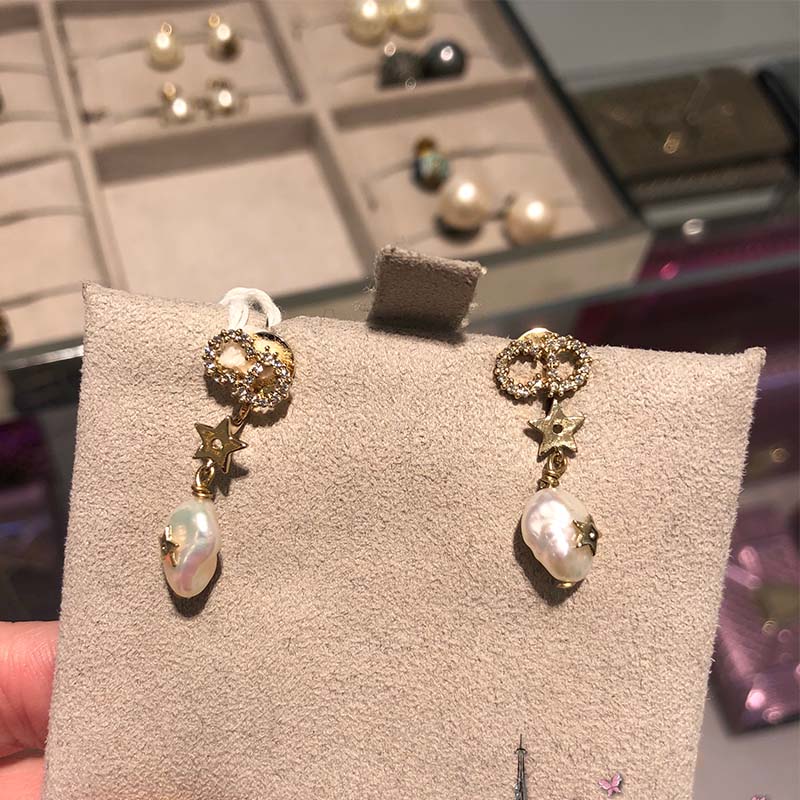 Pair of Dior Women Shiny-D Earrings-White displayed on white background