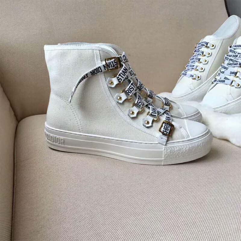 Close-up on lace-up and metal eyelets of Dior White Canvas high-top