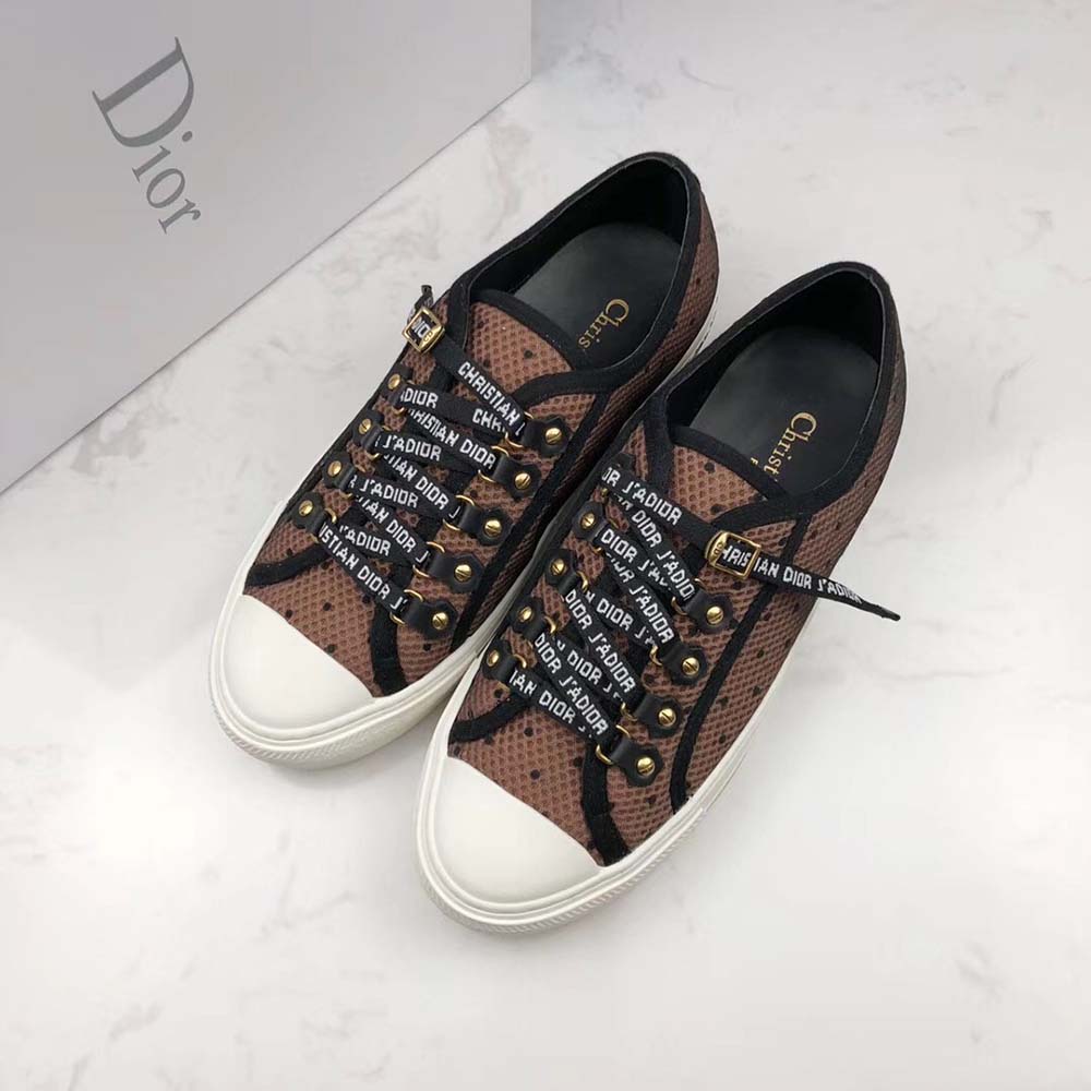 Top angled shot showing plumetis mesh and lace-up detail on Dior sneaker