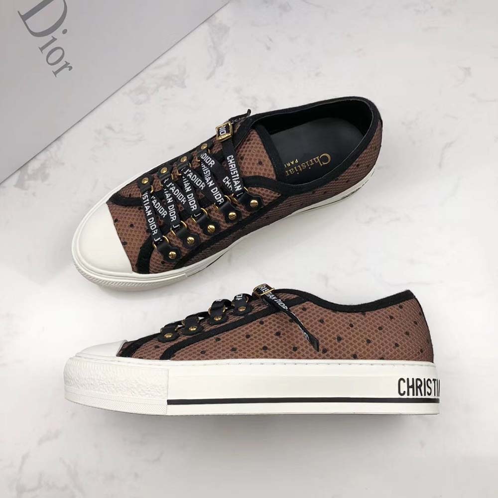 Close-up on Dior logo hardware on Walkndior Plumetis Sneaker brown heel