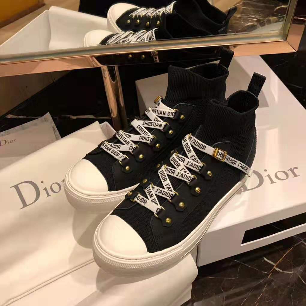 Close-up on Dior embossed logo hardware on sneaker tongue