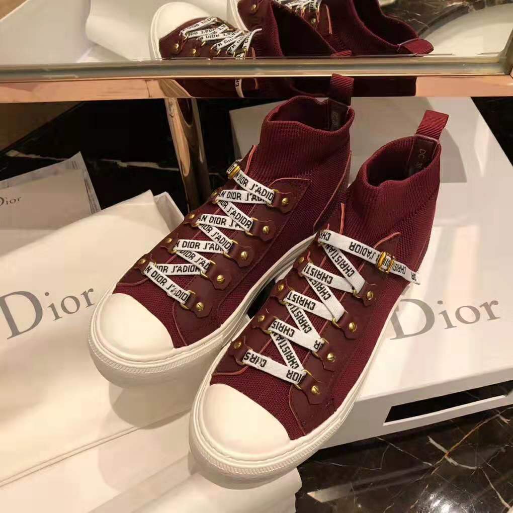 Close-up on red technical knit texture and Dior logo hardware