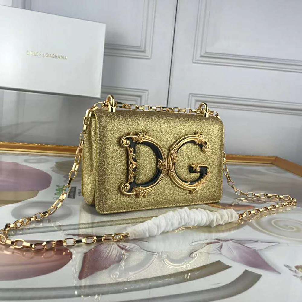 Close-up of gold-tone D&G logo hardware on cross-body bag